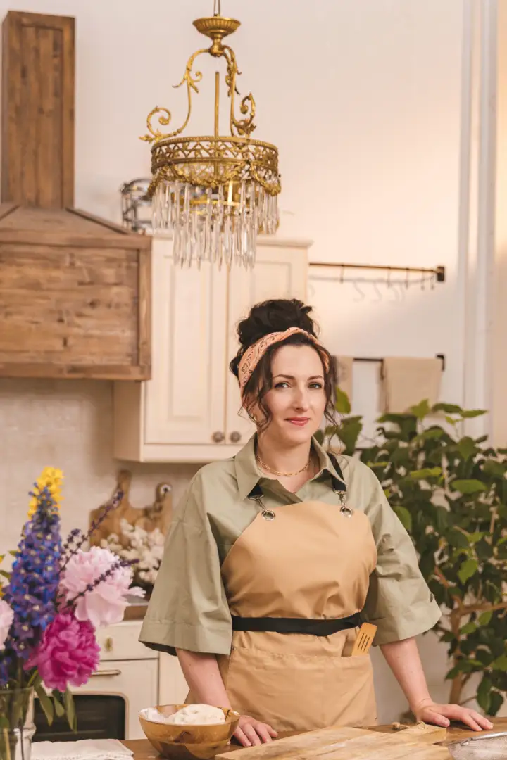 Ines R., owner of a bakery, at her floured bench