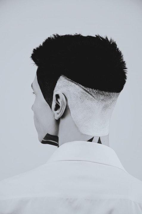 High fade from behind with a hard part shaved in
