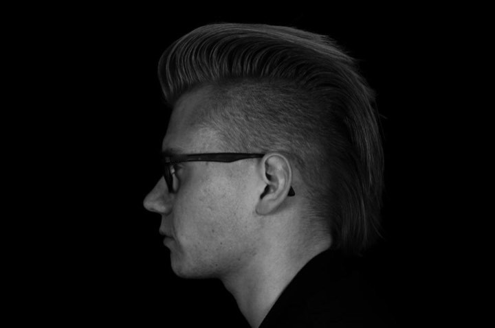 Side profile of a tall, brushed-back pompadour, in black and white