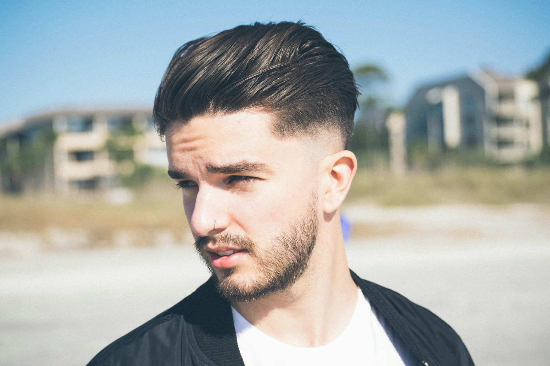 Skin fade blended into a short, shaped beard