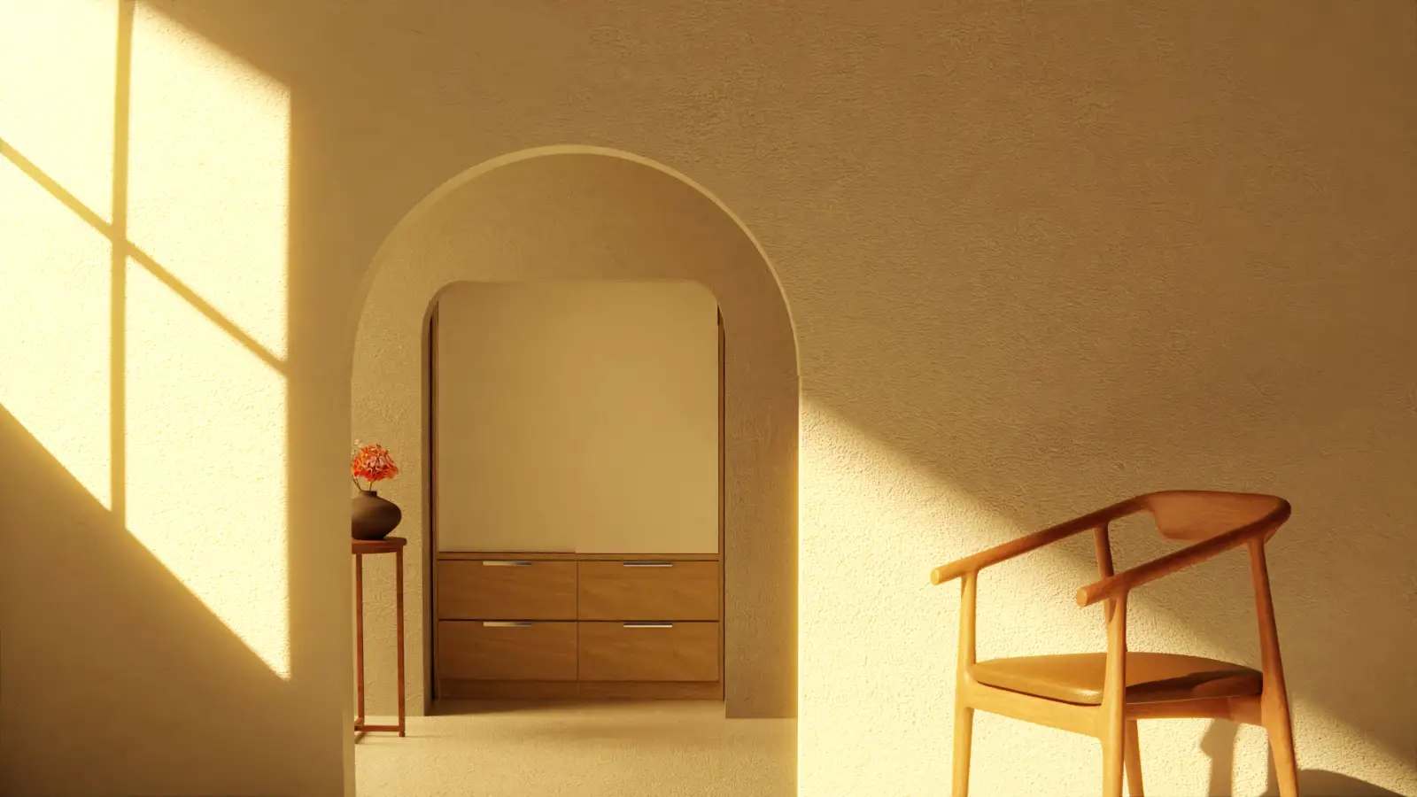 Late sun through a window on a limewashed wall, an arched doorway to an oak cabinet and a cognac leather chair.