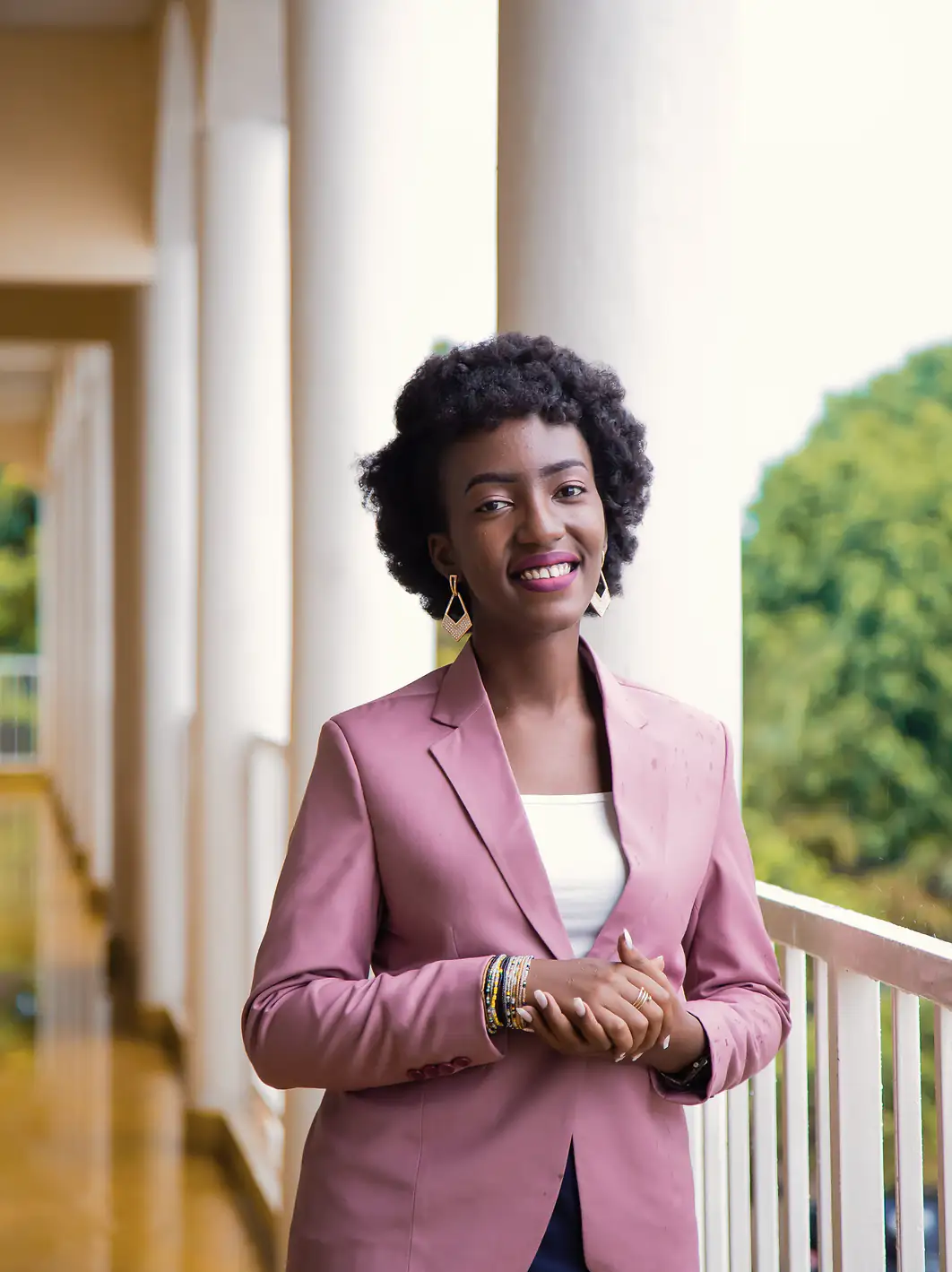 Maren Eskela, founding attorney, smiling on the office's colonnaded balcony.
