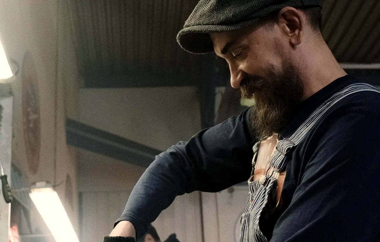 Millrace's owner at work in the shop, checking a car on the lift.