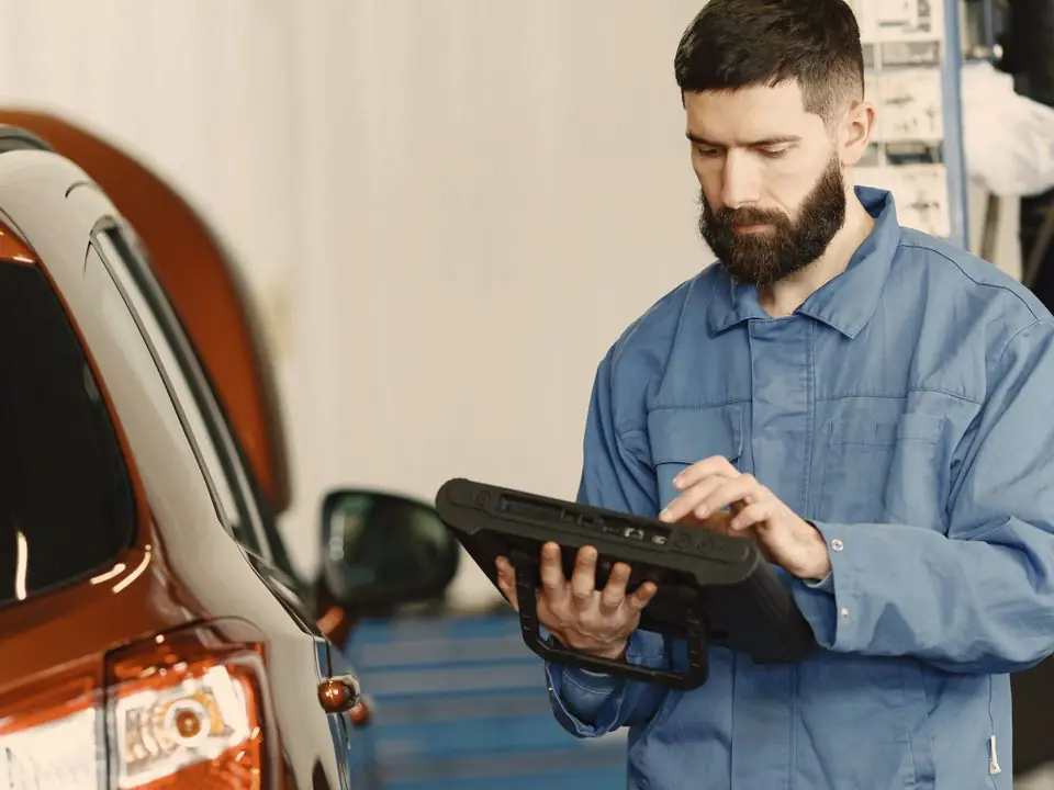 A diagnostic scan tool plugged into a car, showing live engine data.