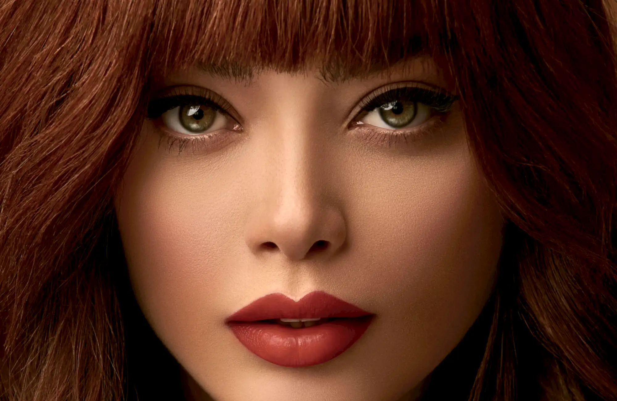 Close-up of a client with an auburn fringe, green eyes and a deep red lip.